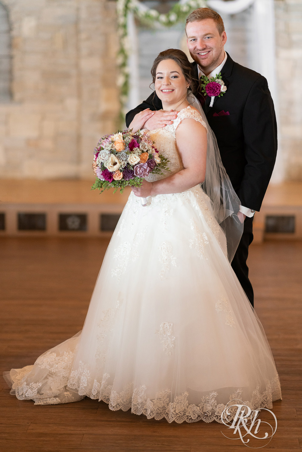 Bride and groom smiling at each other at Glenhaven Events in Farmington, Minnesota.