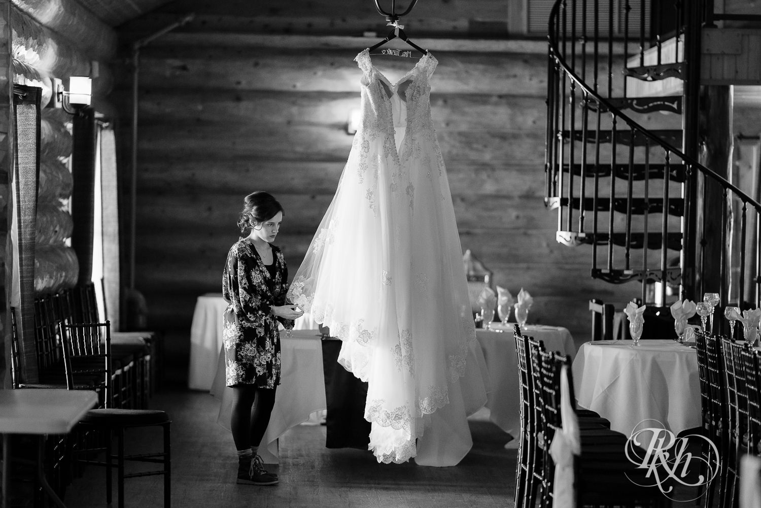 Maid of honor hanging dress for winter wedding at Glenhaven Events in Farmington, Minnesota.