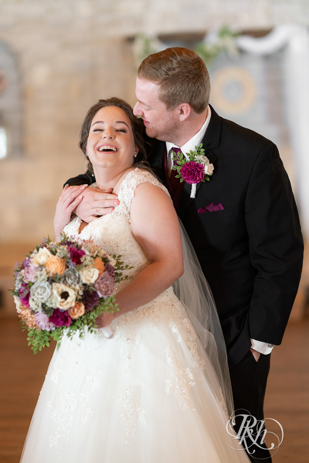 Bride and groom smiling at each other at Glenhaven Events in Farmington, Minnesota.
