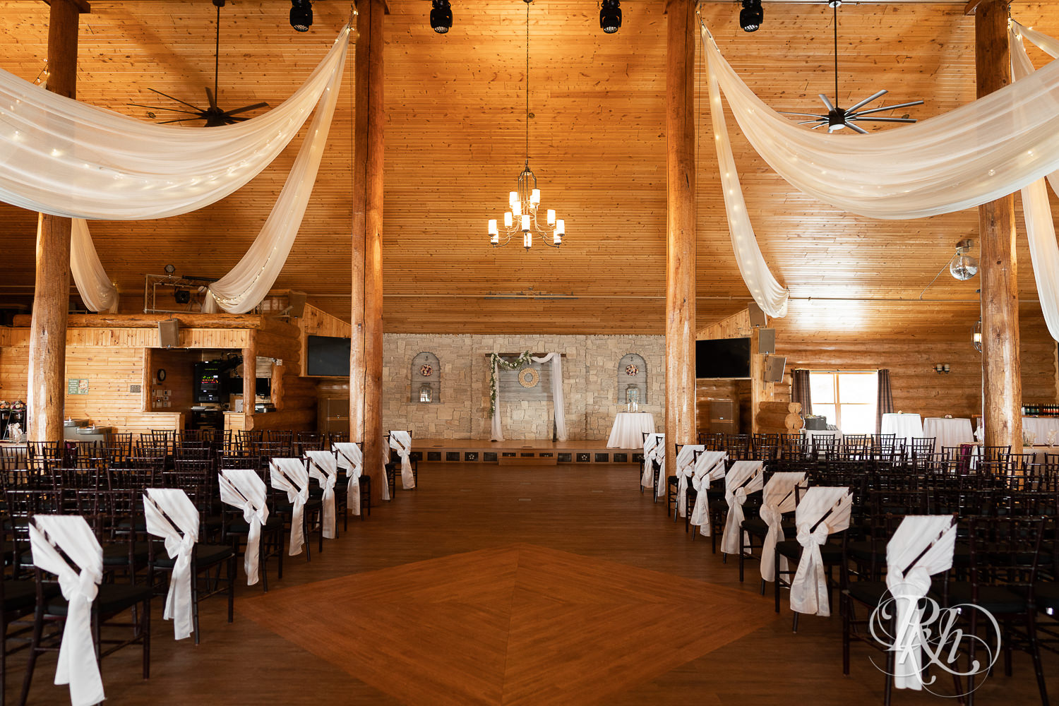 Indoor ceremony setup for winter wedding at Glenhaven Events in Farmington, Minnesota.