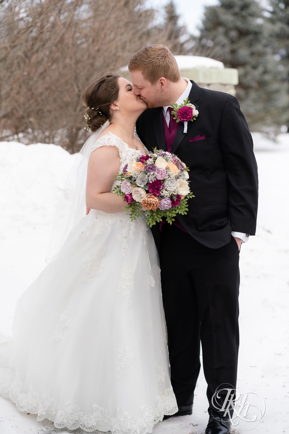 Bride and groom kissing in the snow at Glenhaven Events in Farmington, Minnesota.