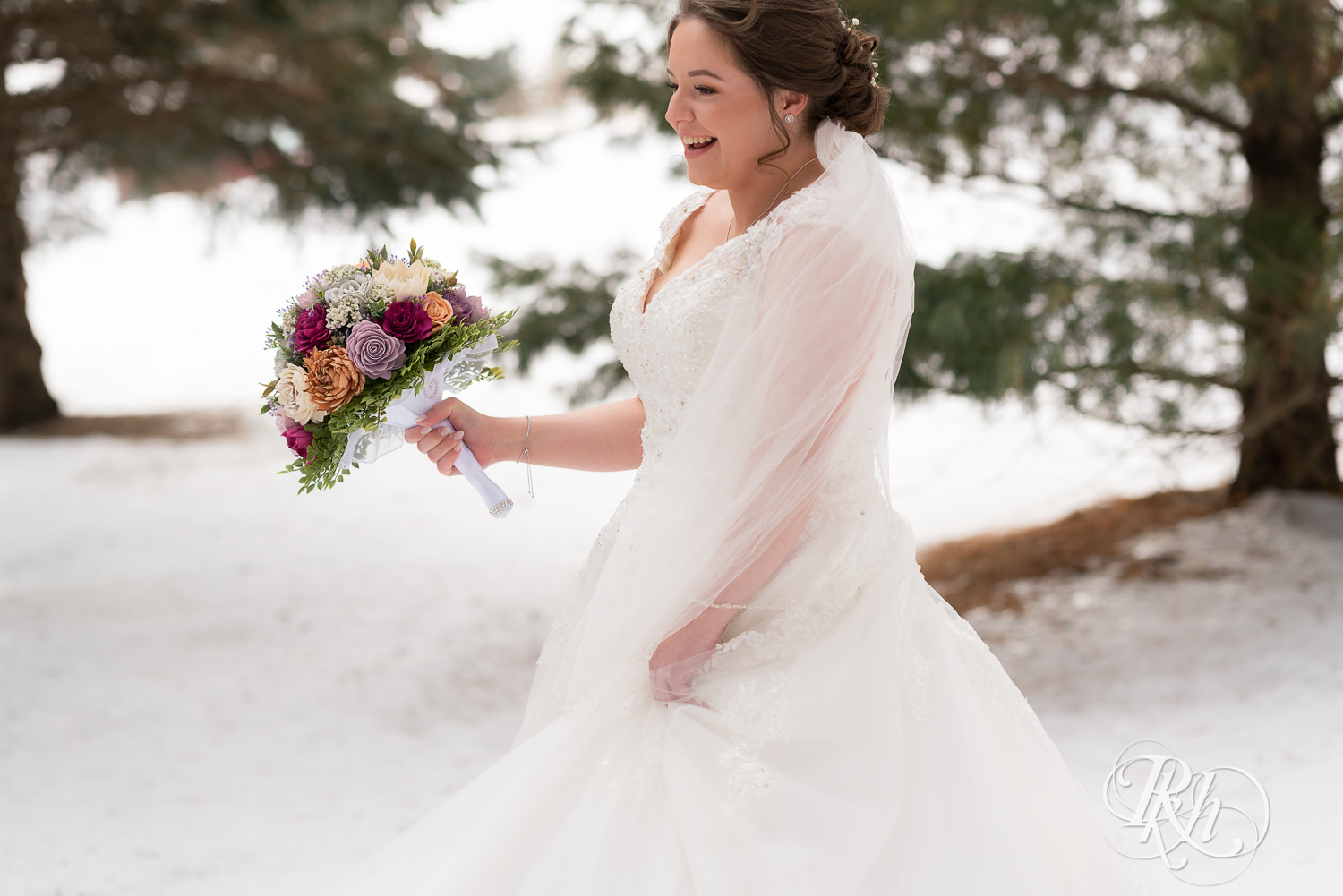 Bride dancing in the snow at Glenhaven Events in Farmington, Minnesota.