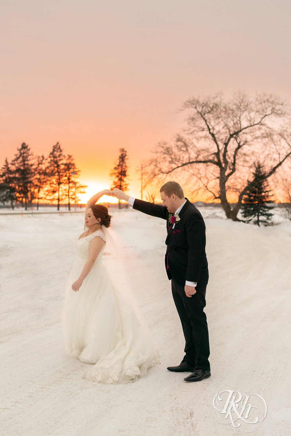 Bride and groom kissing at sunset in snow at Glenhaven Events in Farmington, Minnesota.