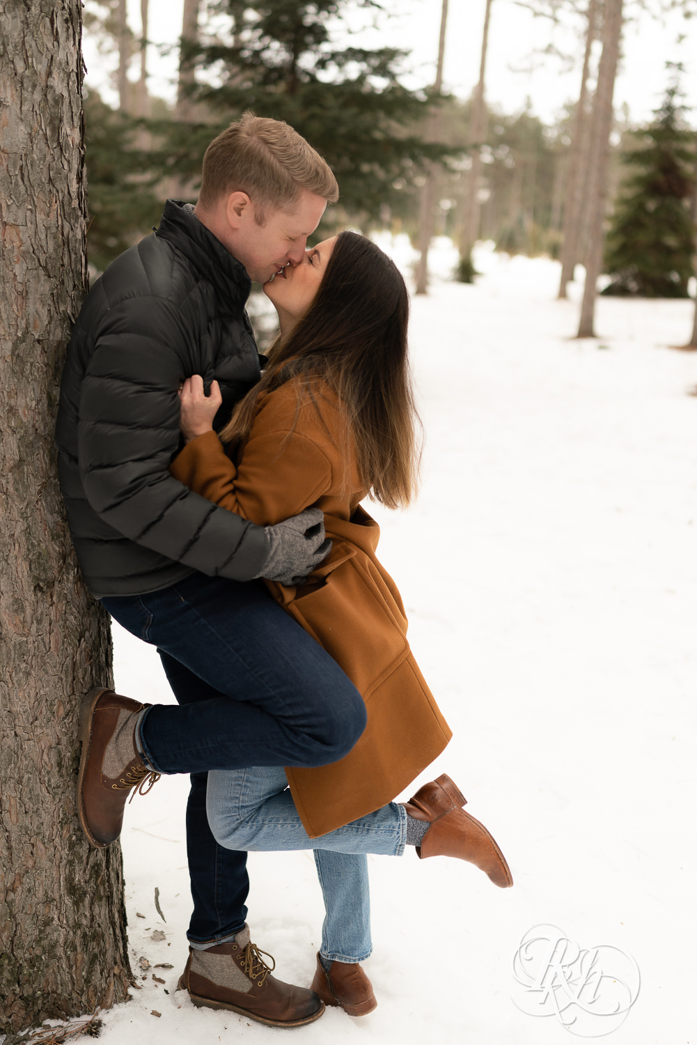 Man and woman kissing in the snow at Hansen Tree Farm in Anoka, Minnesota.
