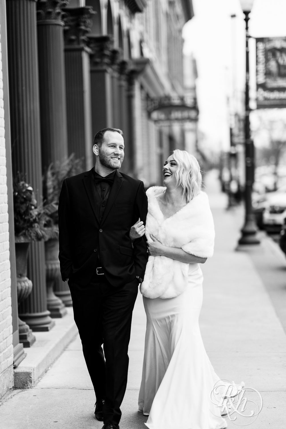 Bride and groom walking down road in front of 3 Ten Event Venue in Faribault, Minnesota.