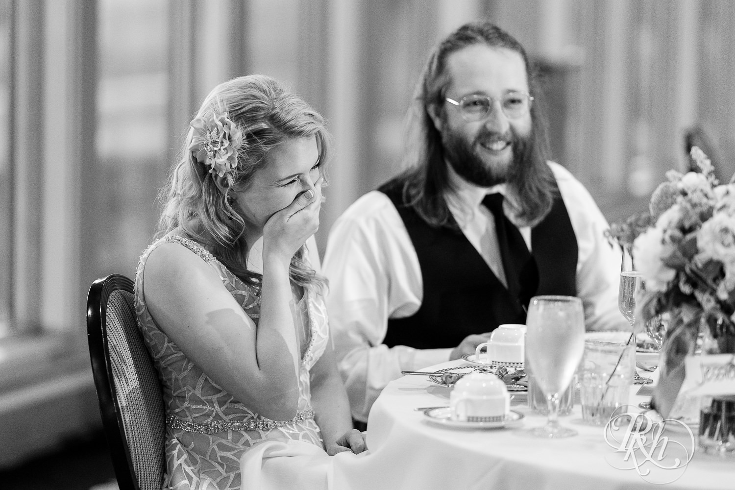 Bride laughs at reception at Rush Creek Golf Club in Maple Grove, Minnesota.