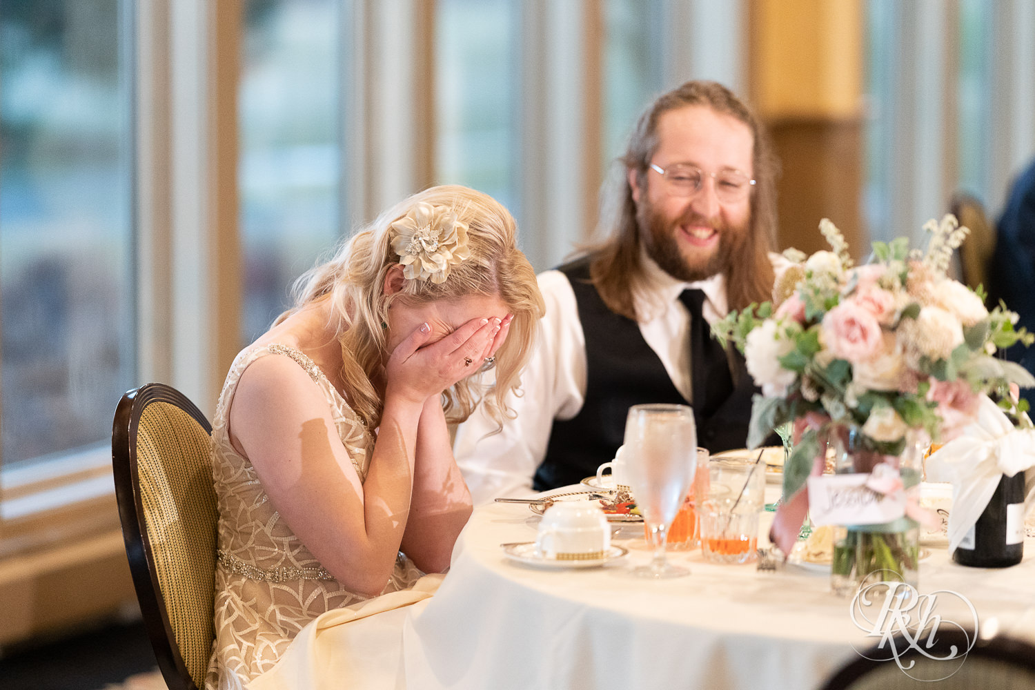 Bride laughs at reception at Rush Creek Golf Club in Maple Grove, Minnesota.