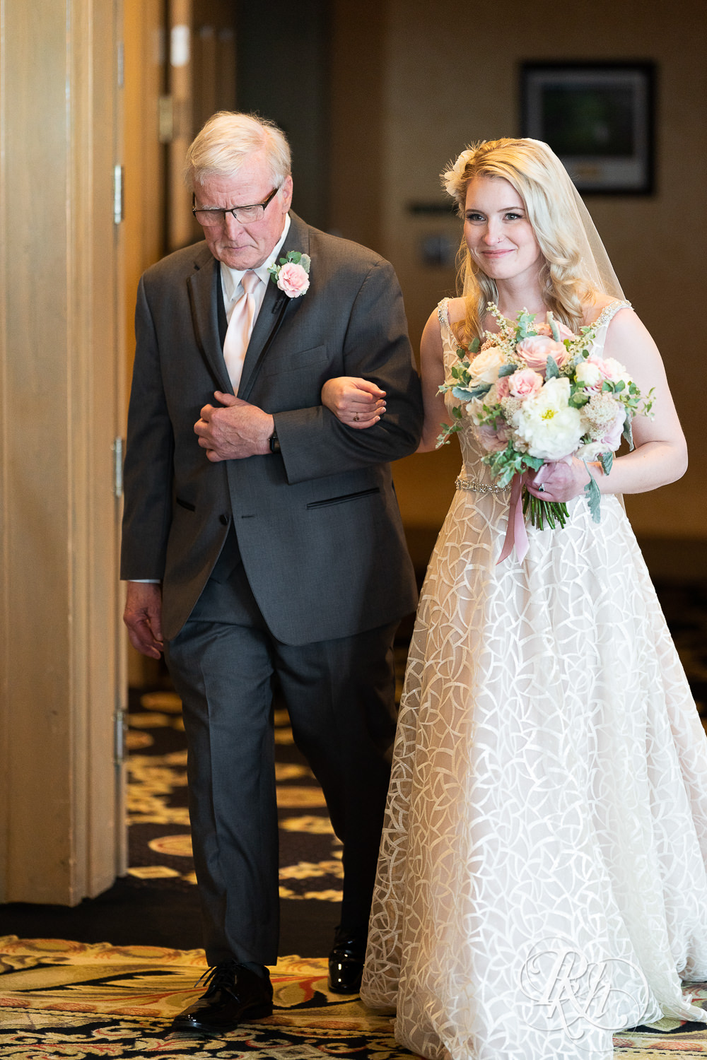 Bride walks down the aisle at indoor wedding at Rush Creek Golf Club in Maple Grove, Minnesota.