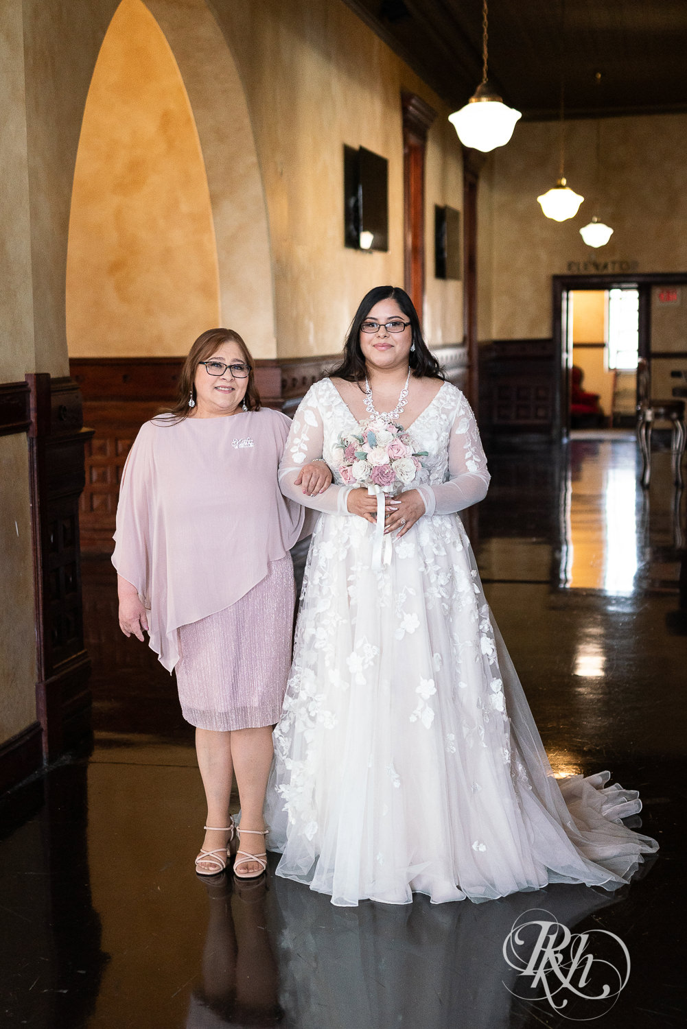 Bride walking down the aisle with her mom at the Historic Concord Exchange in Saint Paul, Minnesota.