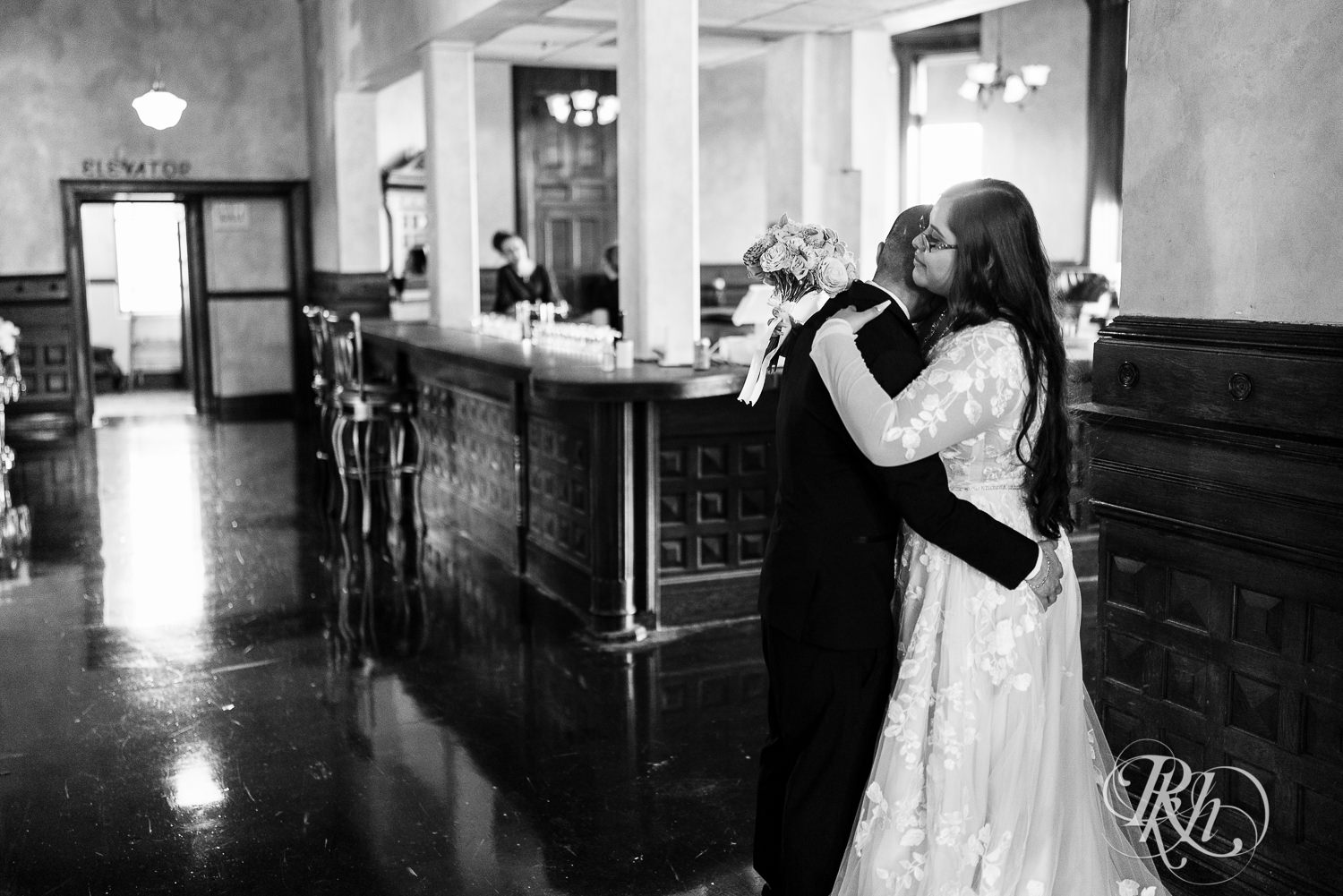 Bride and groom hug after wedding ceremony at the Historic Concord Exchange in Saint Paul, Minnesota.