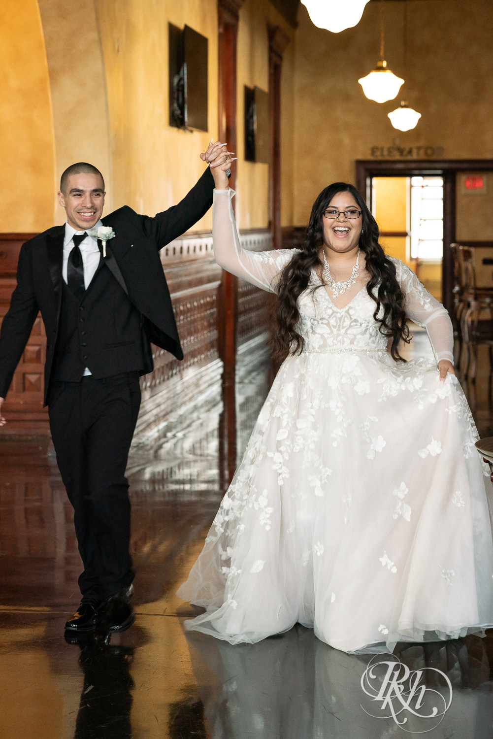 Mexican bride and groom entering reception at the Historic Concord Exchange in Saint Paul, Minnesota.