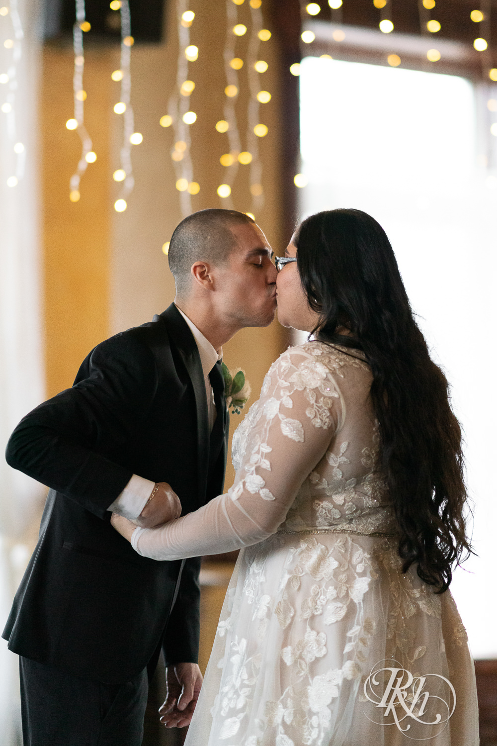 Mexican bride and groom kissing in the Historic Concord Exchange in Saint Paul, Minnesota.