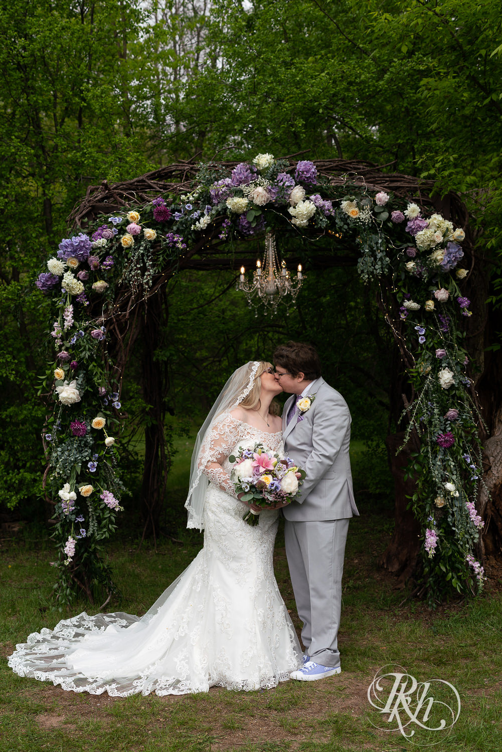 Bride and groom kissing in front of alter at Hope Glen Farm in Cottage Grove, Minnesota.