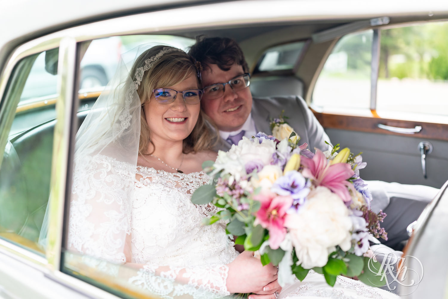 Bride and groom in Rolls Royce at Hope Glen Farm in Cottage Grove, Minnesota.