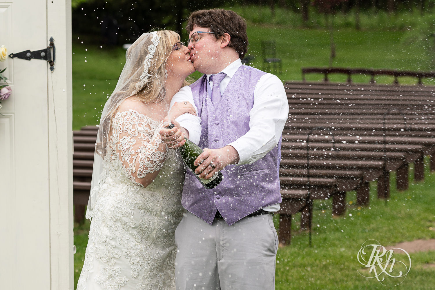 Bride and groom spray champagne at Hope Glen Farm in Cottage Grove, Minnesota.