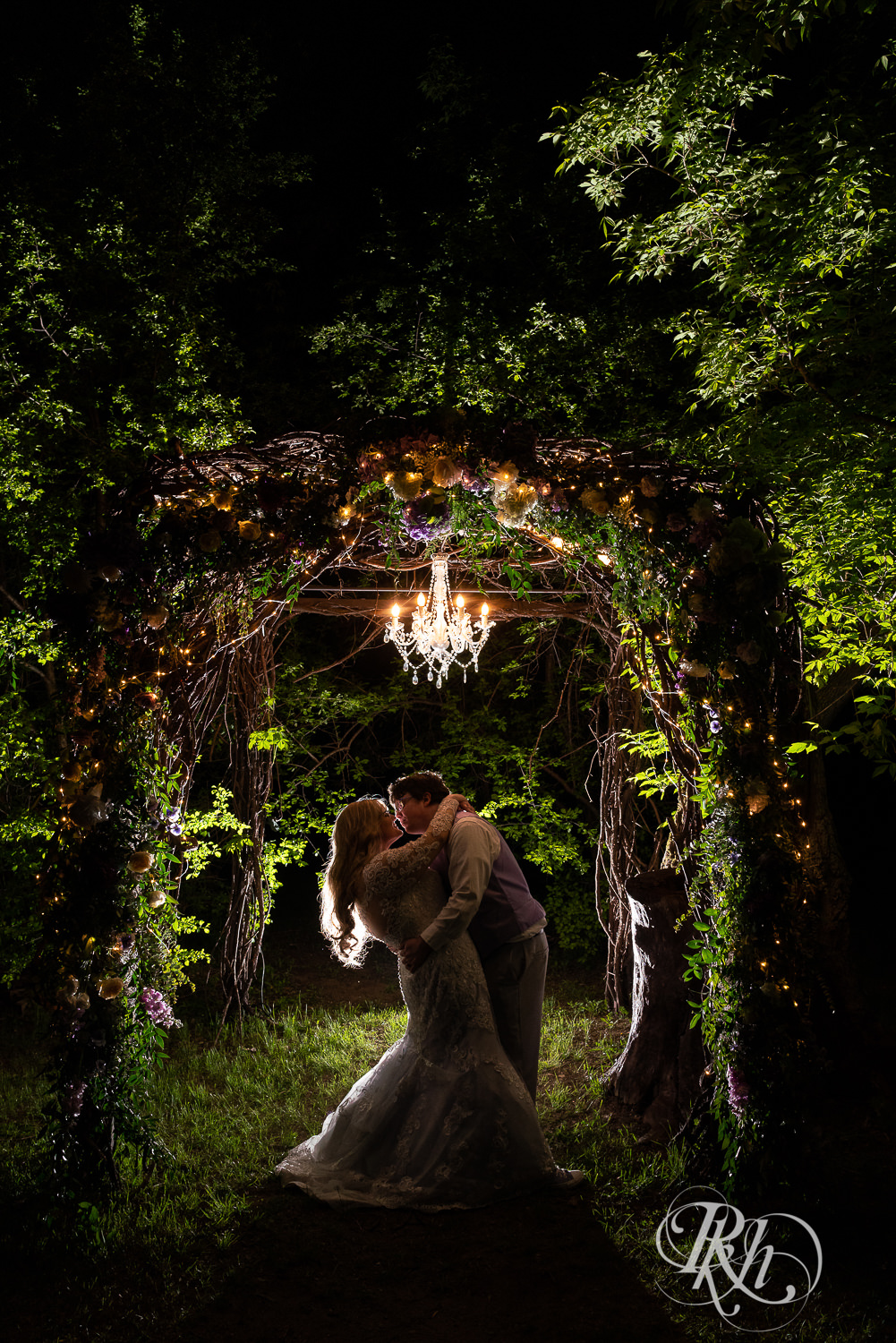 Bride and groom dance at night under lit alter at Hope Glen Farm in Cottage Grove, Minnesota.