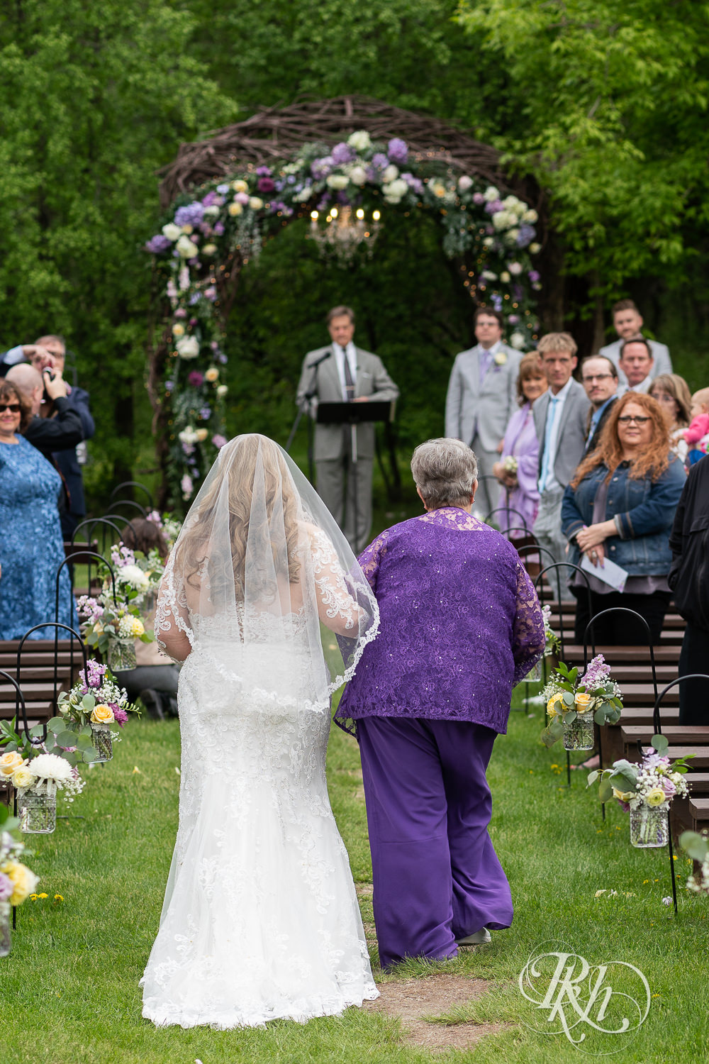 Bride walking down the aisle before ceremony at Hope Glen Farm in Cottage Grove, Minnesota.