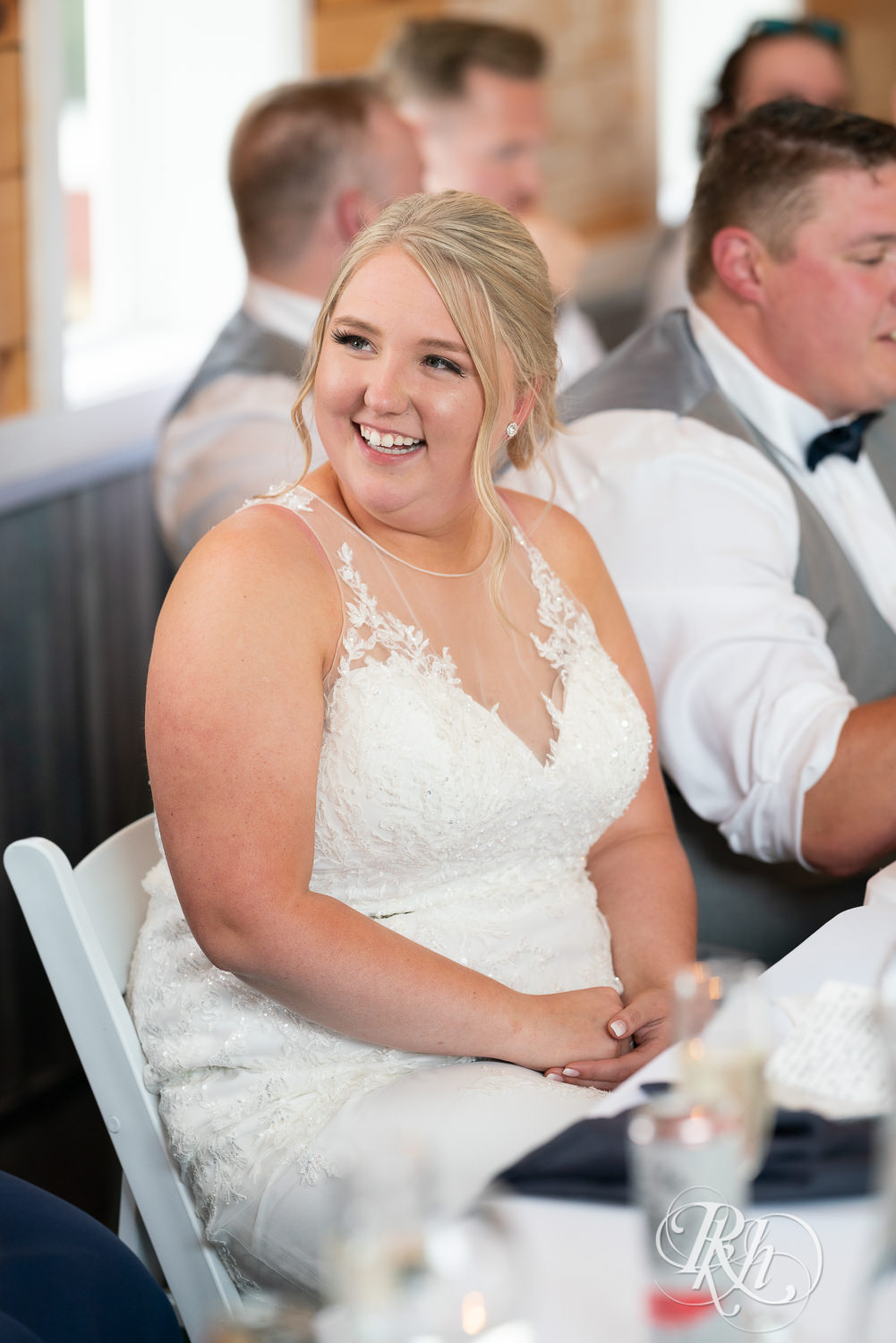 Bride laughing during reception at Barn at Mirror Lake in Mondovi, Wisconsin.