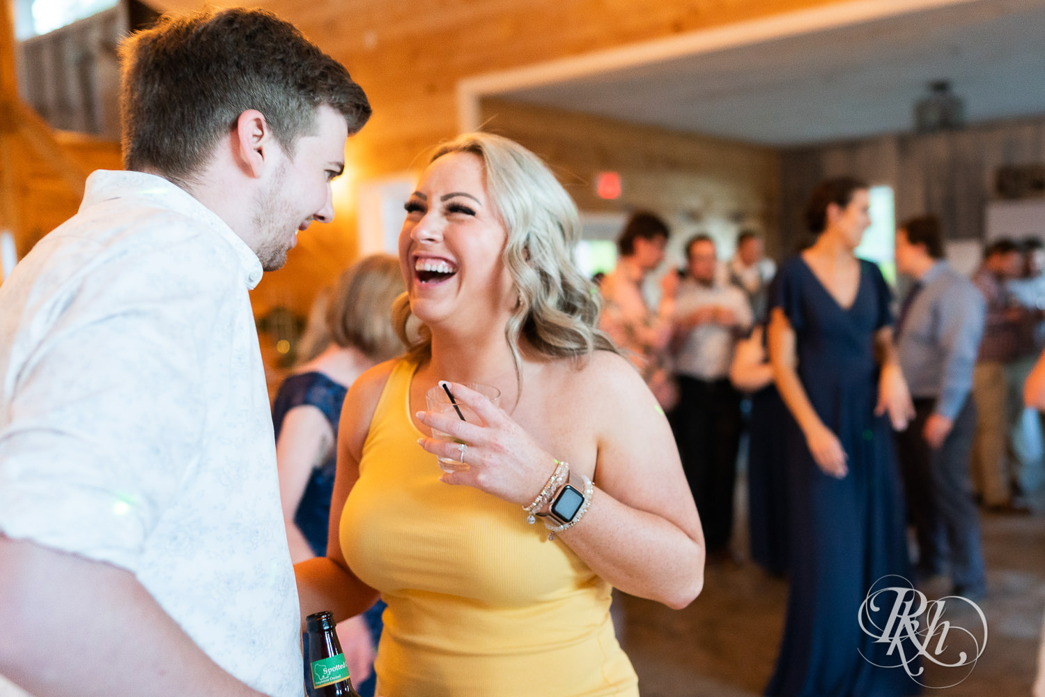 Guests dance at wedding reception at Barn at Mirror Lake in Mondovi, Wisconsin.