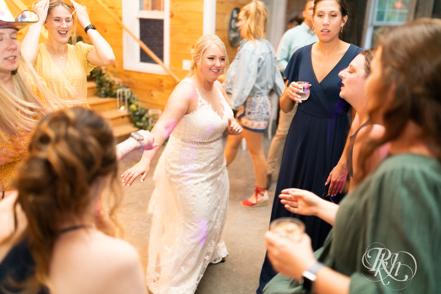 Guests dance at wedding reception at Barn at Mirror Lake in Mondovi, Wisconsin.