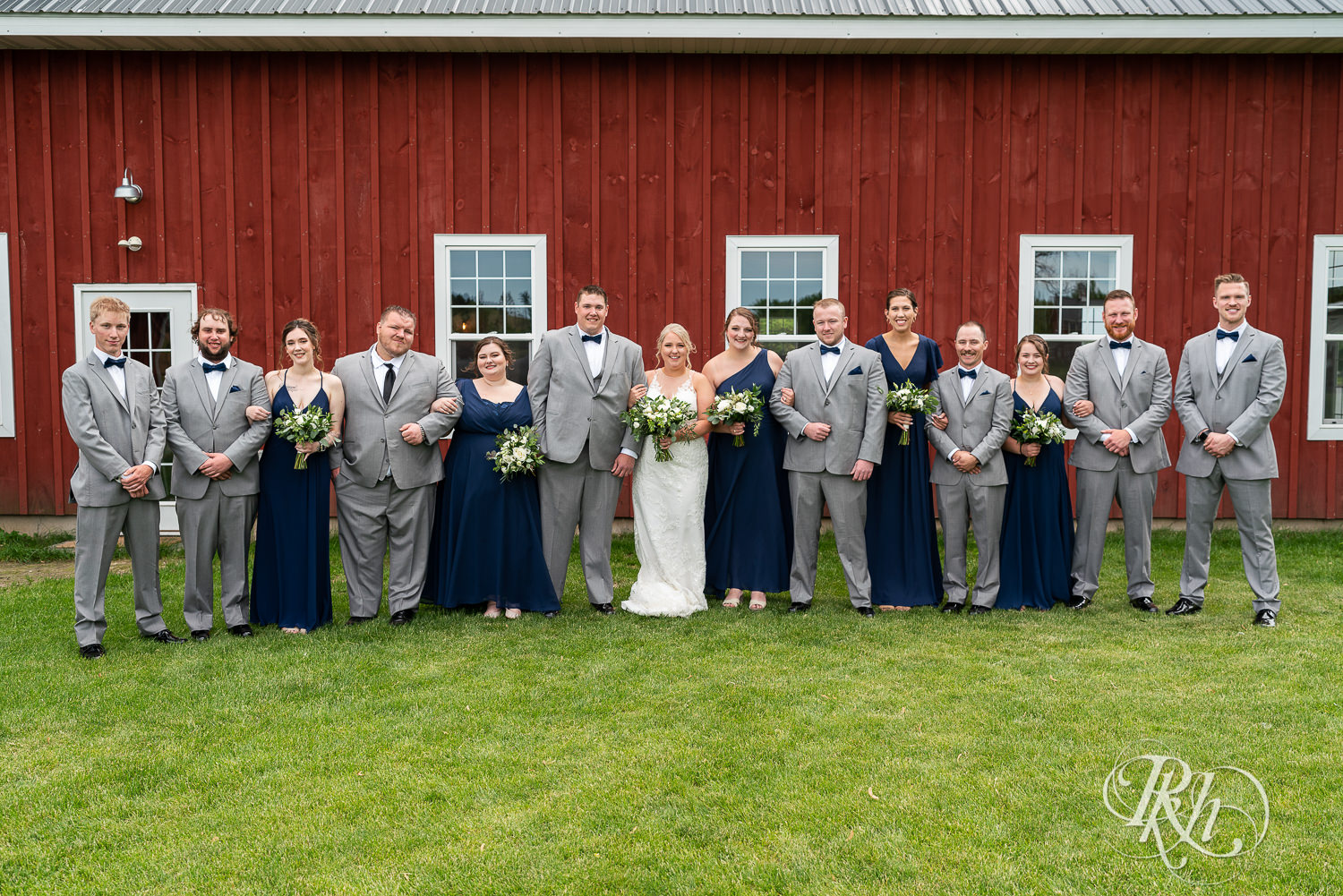 Wedding party in front of barn at Barn at Mirror Lake in Mondovi, Wisconsin.