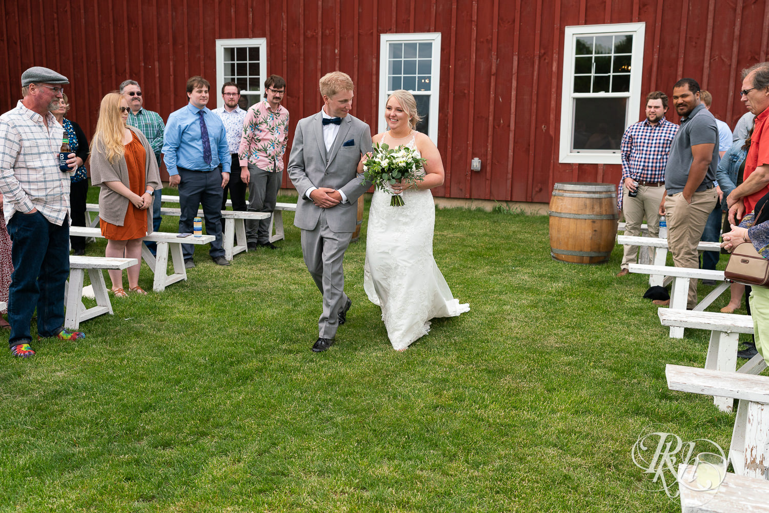 Bride walking down the aisle with her brother at Barn at Mirror Lake in Mondovi, Wisconsin.