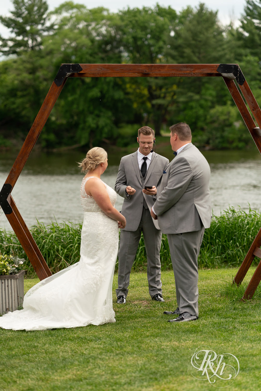 Bride and groom at lakefront wedding ceremony at Barn at Mirror Lake in Mondovi, Wisconsin.