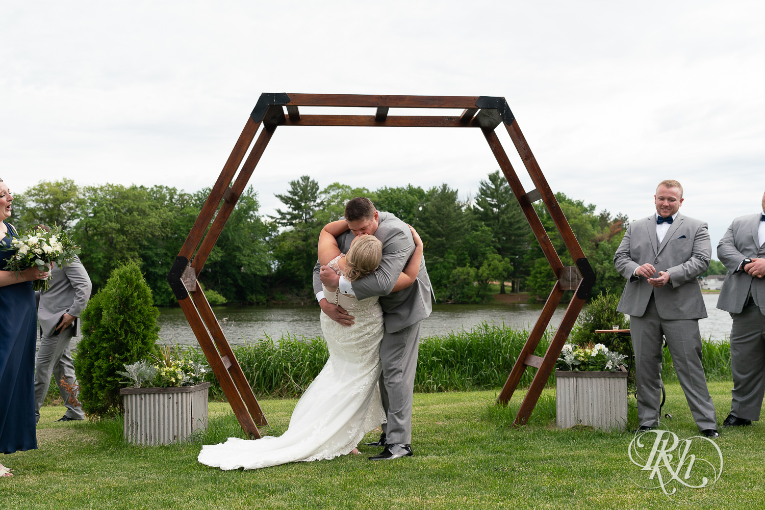 Bride and groom at lakefront wedding ceremony at Barn at Mirror Lake in Mondovi, Wisconsin.