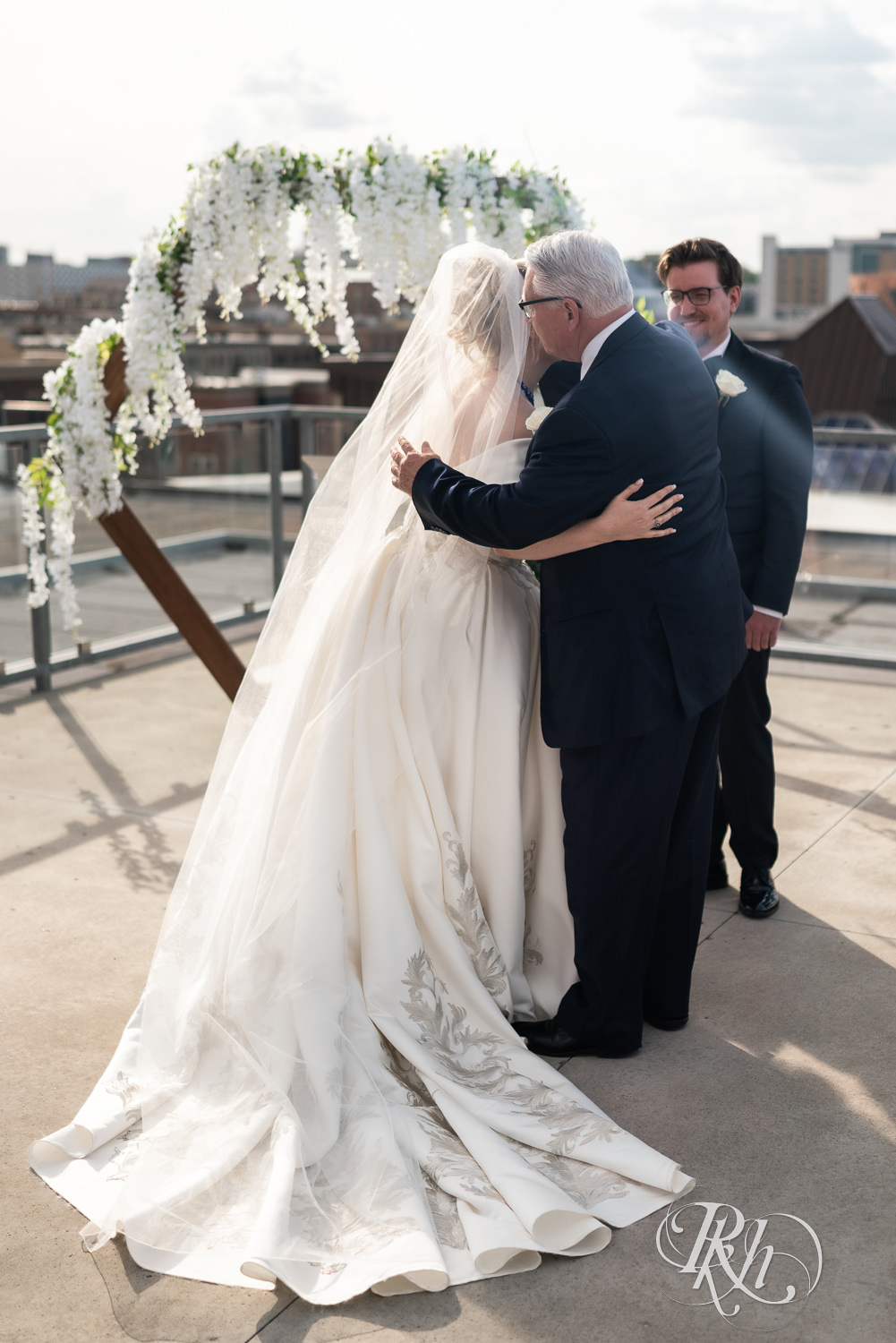 Bride walking down the aisle with father at rooftop summer wedding at Abulae in Saint Paul, Minnesota.