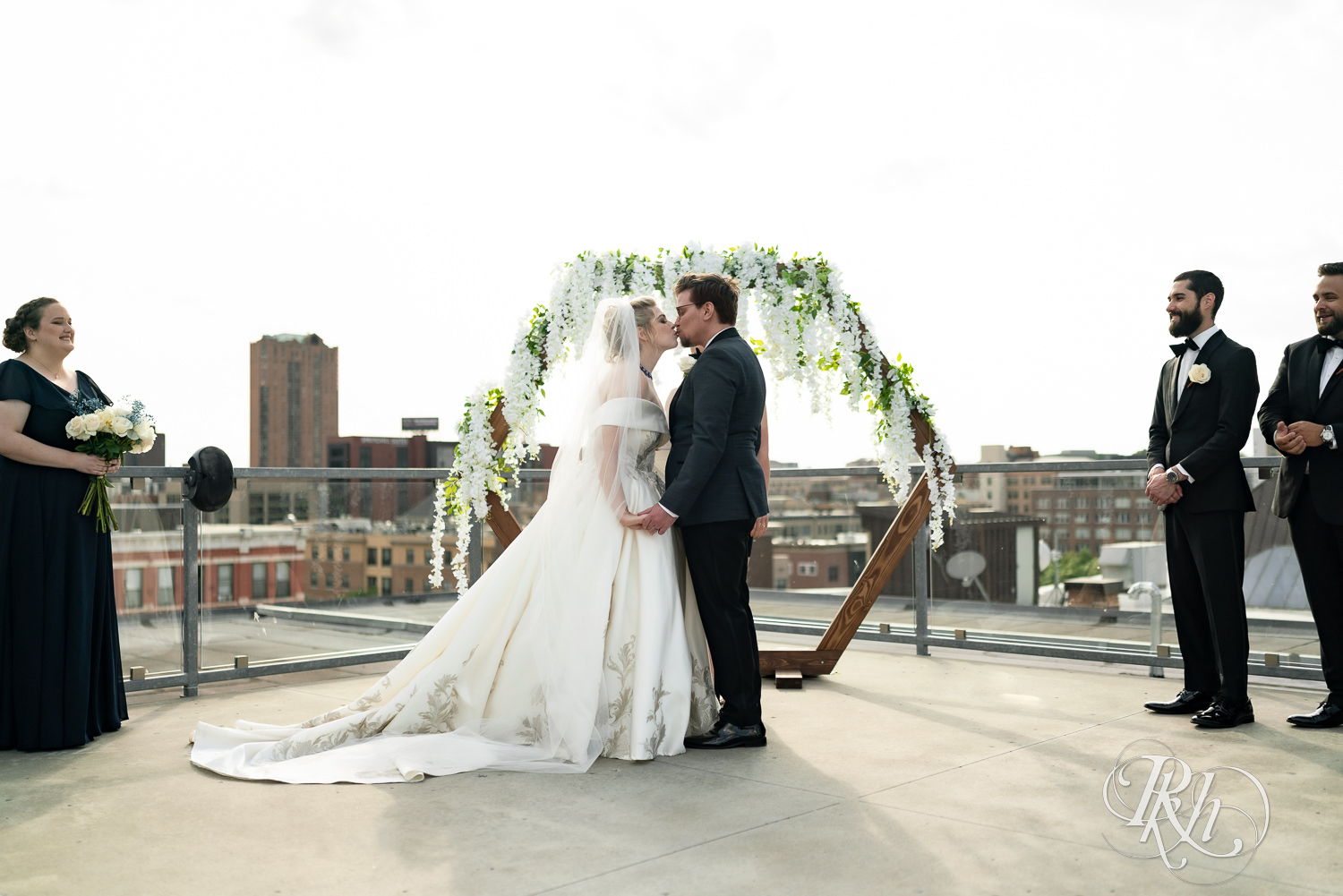 Bride and groom share first kiss on the rootop at Abulae in Saint Paul, Minnesota.