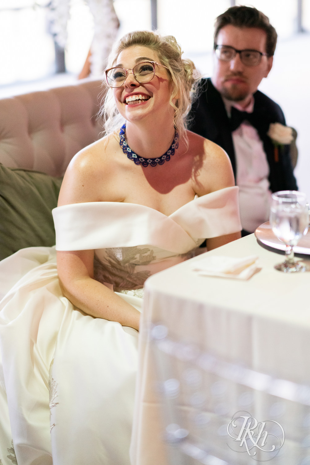 Bride laughs candidly at reception inside Abulae in Saint Paul, Minnesota.
