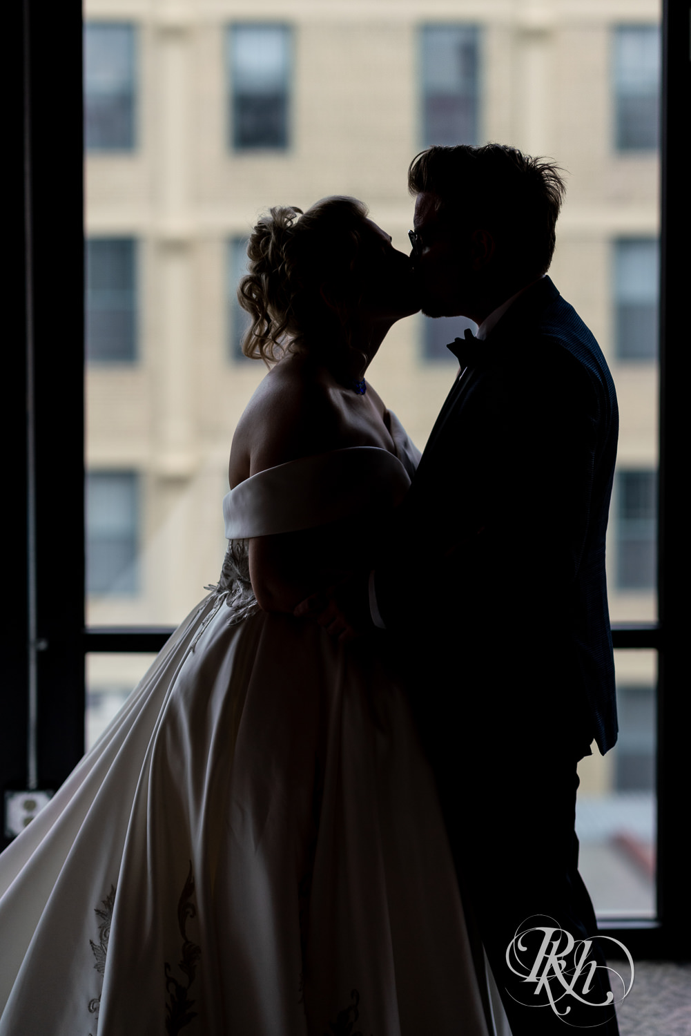 Bride and groom kiss in silhouette at Abulae in Saint Paul, Minnesota.