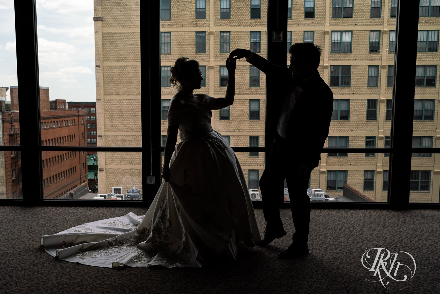 Bride and groom dance in silhouette at Abulae in Saint Paul, Minnesota.