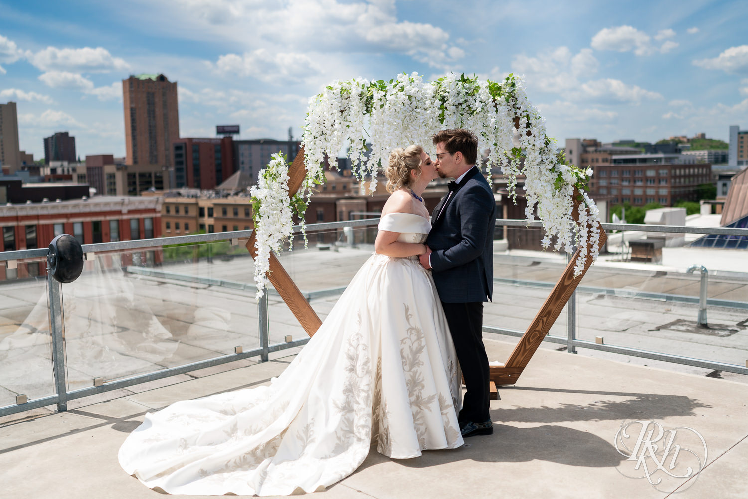 Bride and groom kiss on rooftop at Abulae in Saint Paul, Minnesota.