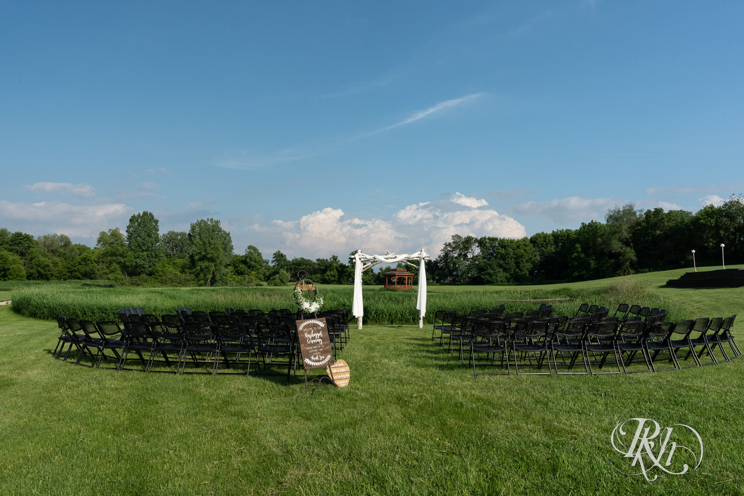 Outdoor summer wedding ceremony setup at Barn at Crocker's Creek in Faribault, Minnesota.