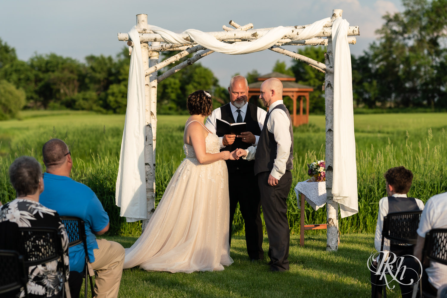 Bride and groom at alter at sunset ceremony at Barn at Crocker's Creek in Faribault, Minnesota.