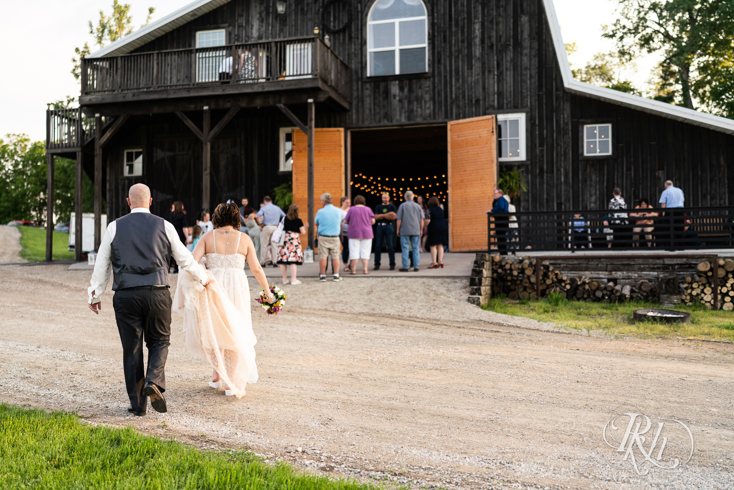 Bride and groom walking to wedding reception at Barn at Crocker's Creek in Faribault, Minnesota.