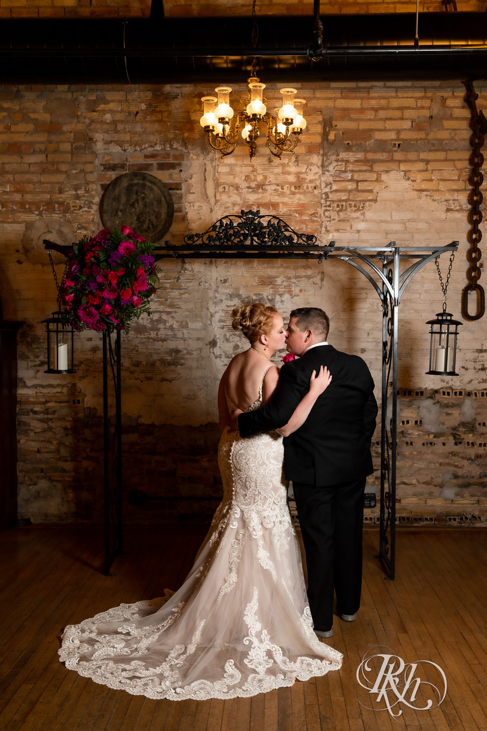 Bride and groom kiss at alter at Kellerman's Event Center in White Bear Lake, Minnesota.