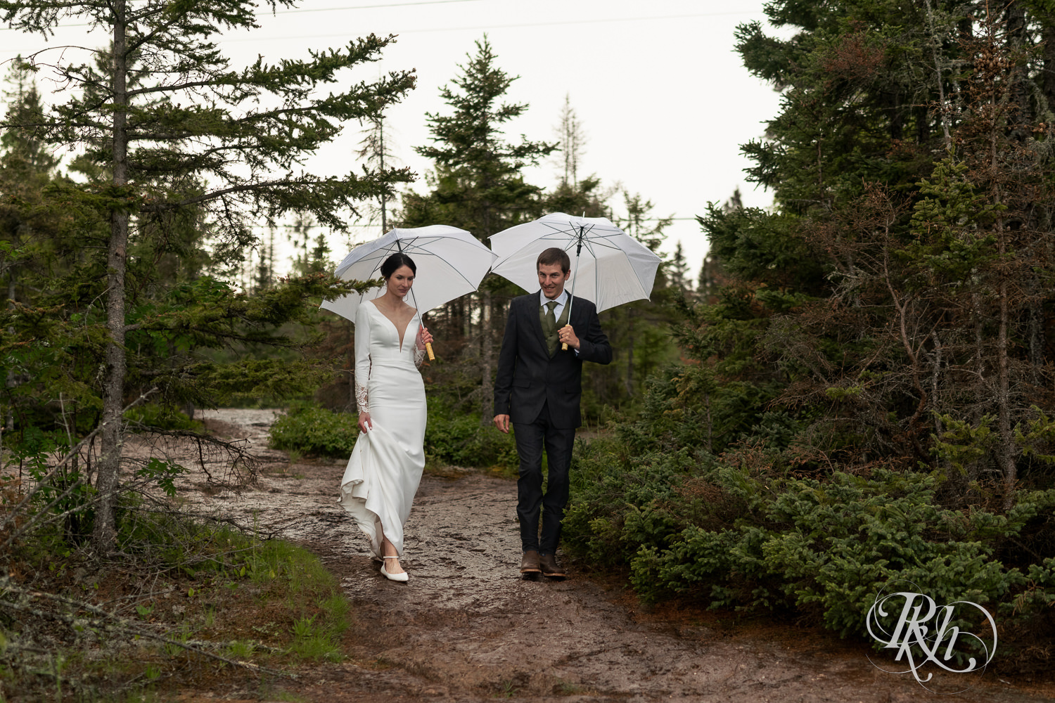 Bride and groom walk in rain at their North Shore elopement in Tofte, Minnesota.