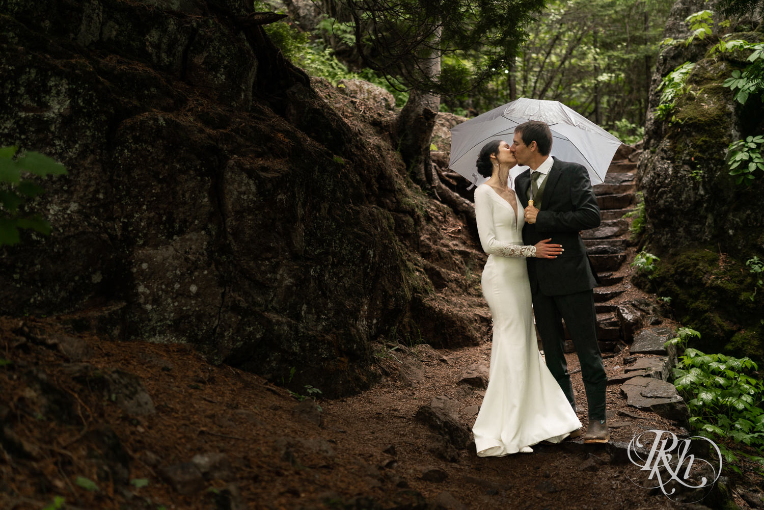 Bride and groom kiss in rain at their North Shore elopement in Tofte, Minnesota.