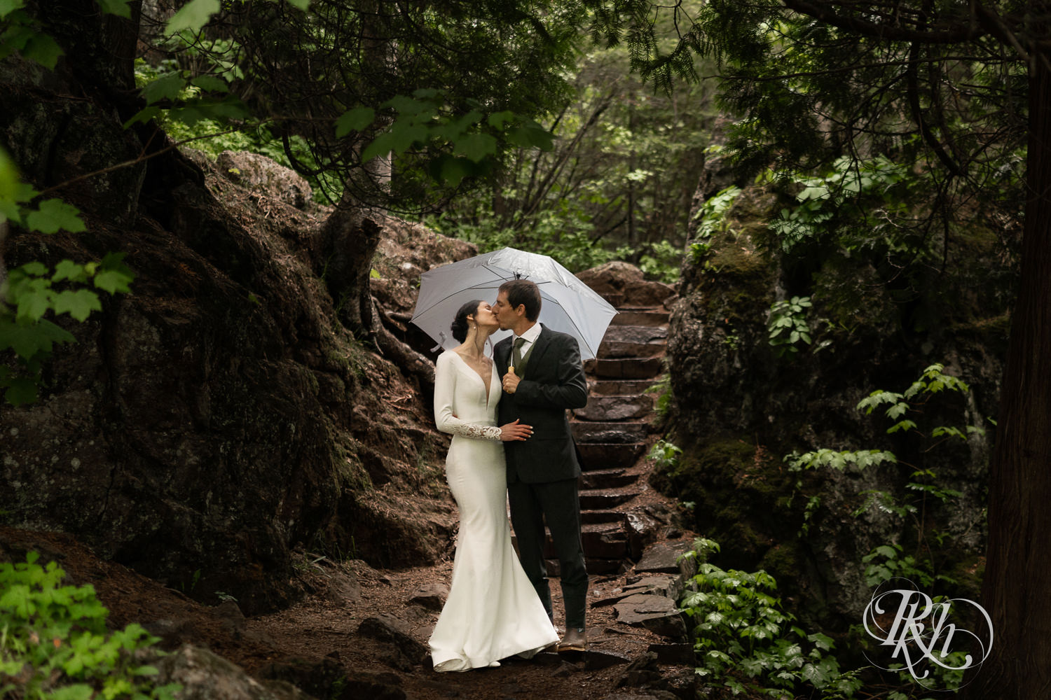 Bride and groom kiss in rain at their North Shore elopement in Tofte, Minnesota.