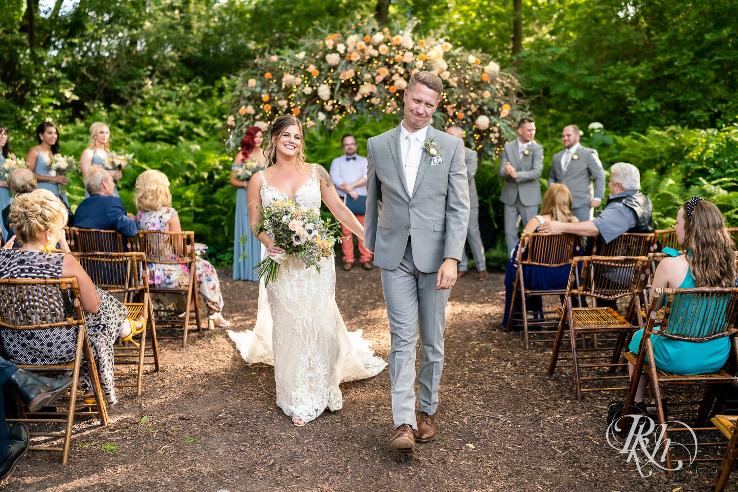 Bride and groom walking down aisle after wedding ceremony at Camrose Hill Flower Farm in Stillwater, Minnesota.