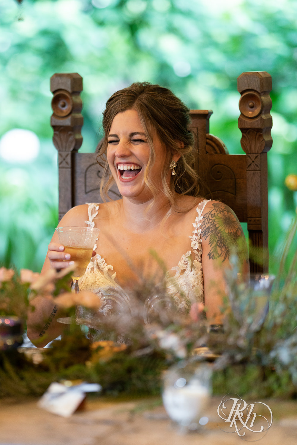 Candid reception bride laughing at Camrose Hill Flower Farm in Stillwater, Minnesota.