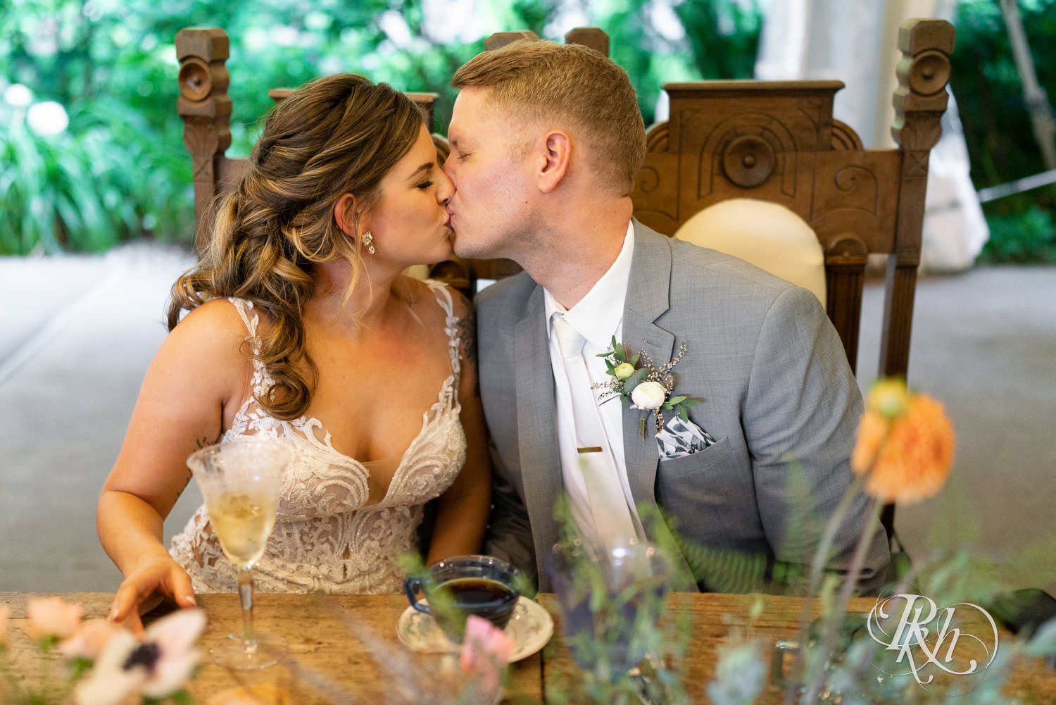 Candid reception bride and groom kiss at Camrose Hill Flower Farm in Stillwater, Minnesota.