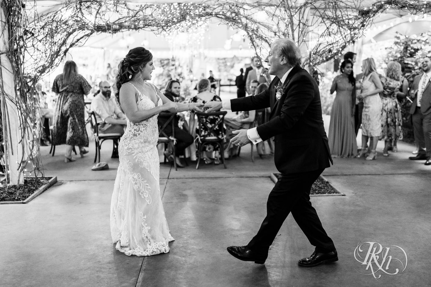 Father and daughter dance at Camrose Hill Flower Farm in Stillwater, Minnesota.