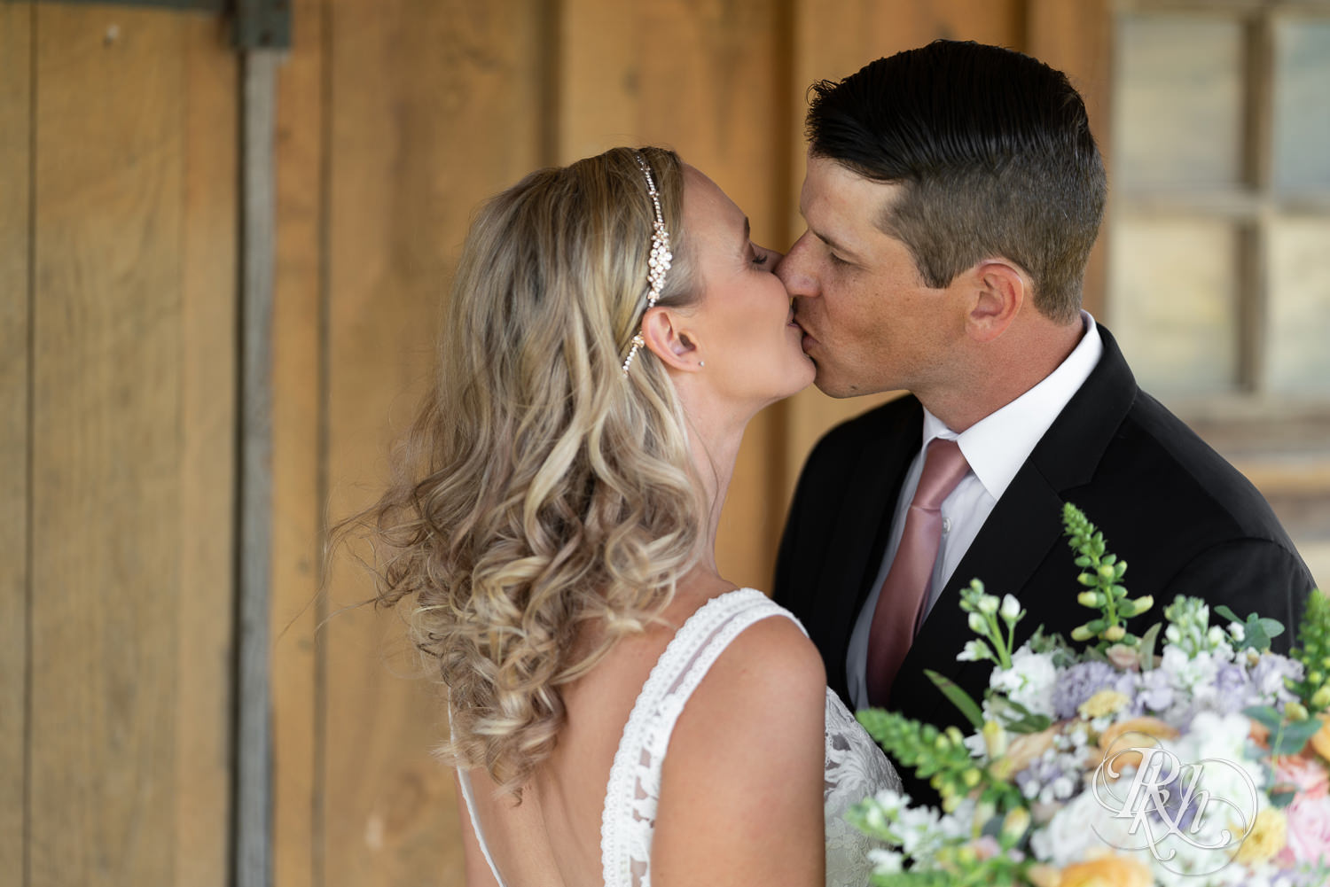 Bride and groom kiss at The Outpost Center in Chaska, Minnesota.
