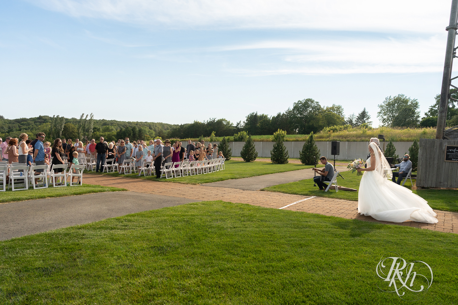 Bride walking down the aisle at The Outpost Center in Chaska, Minnesota.