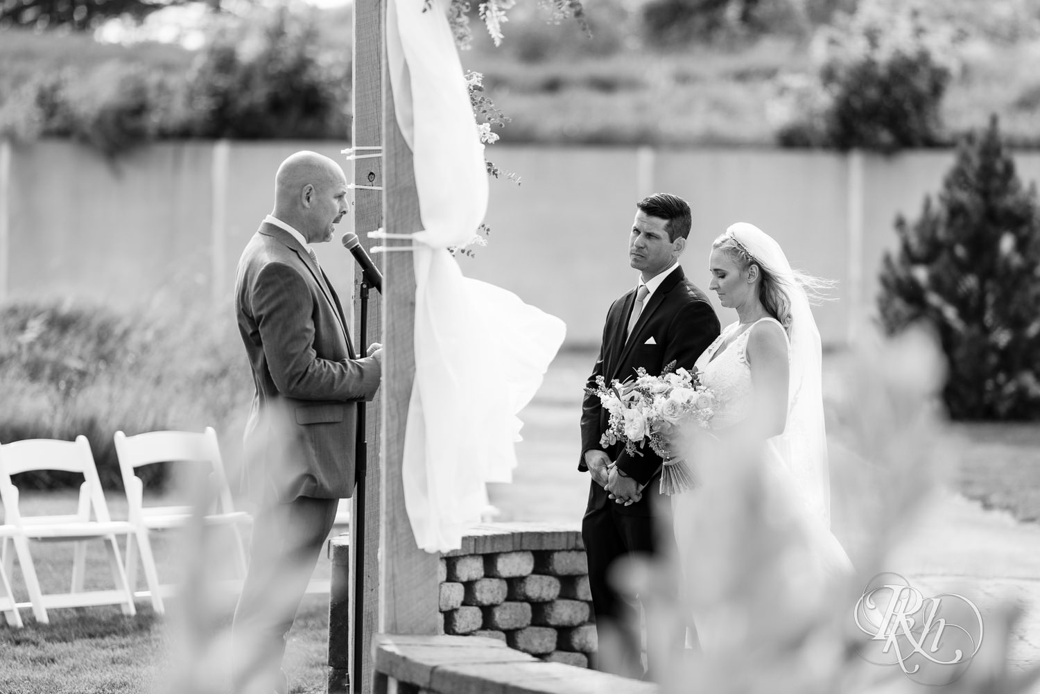 Bride and groom at the alter during wedding ceremony at The Outpost Center in Chaska, Minnesota.