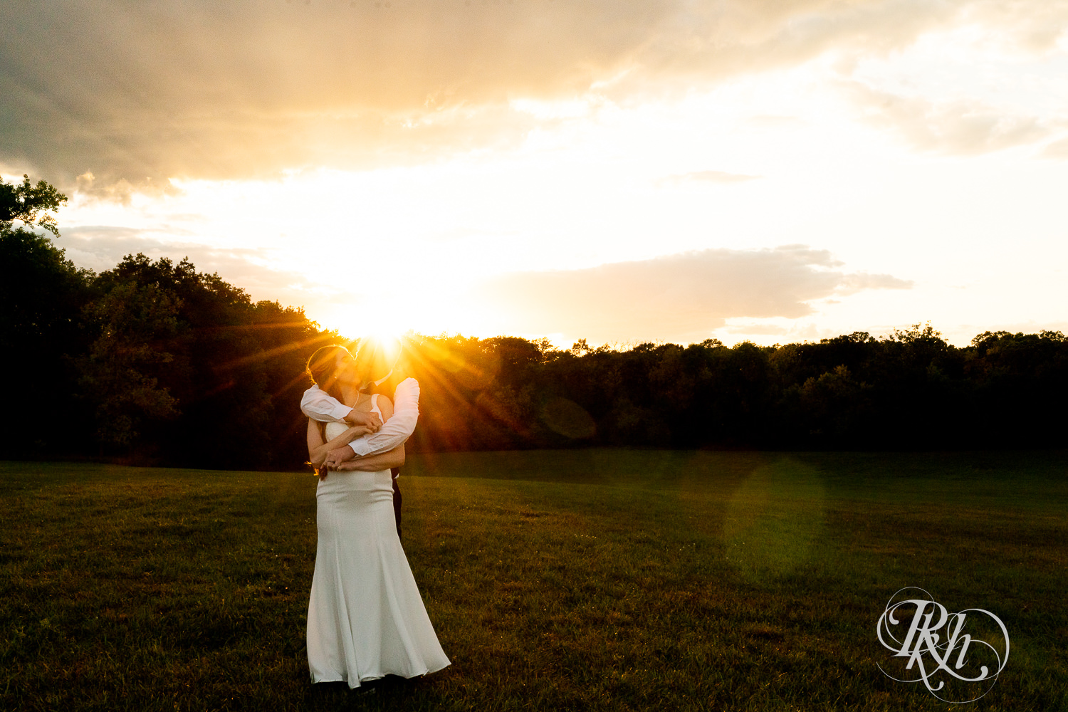 Bride and groom kissing at sunset at Stone Lion Winery and Events in Isanti, Minnesota. 