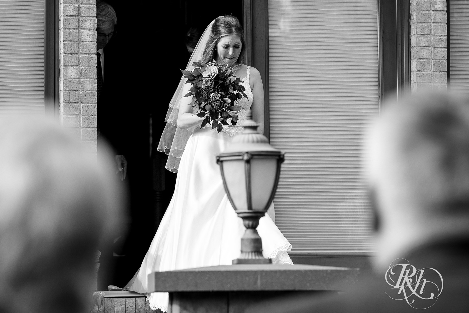 Bride crying walking down the aisle at a summer wedding at Stone Lion Winery and Events in Isanti, Minnesota. 